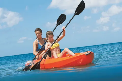 Two guests kayaking on the ocean at Dreams Riviera Cancun Resort & Spa.