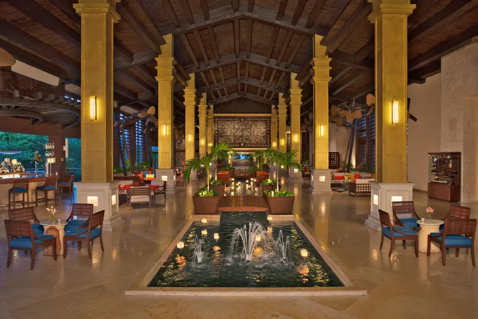 Open-air lobby with fountains and lounge seating at Dreams Riviera Cancun Resort & Spa.