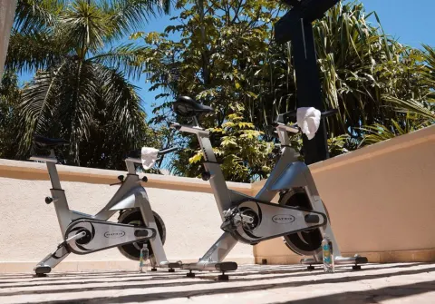 Outdoor stationary bikes on a terrace at Dreams Riviera Cancun Resort & Spa.
