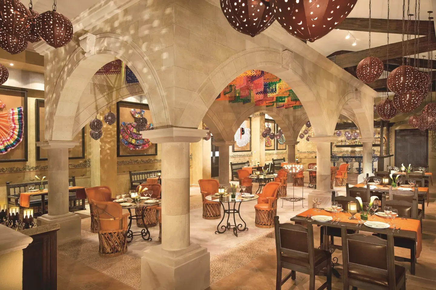 Mexican-style dining room with arches at Dreams Riviera Cancun Resort & Spa.