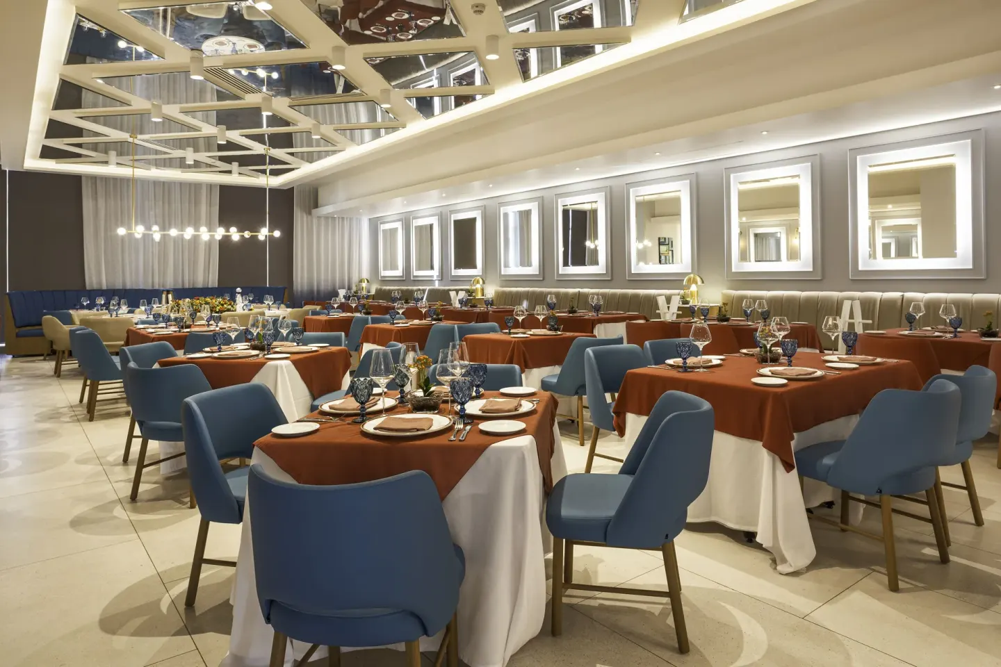 Elegant dining room with blue chairs at Dreams Riviera Cancun Resort & Spa.