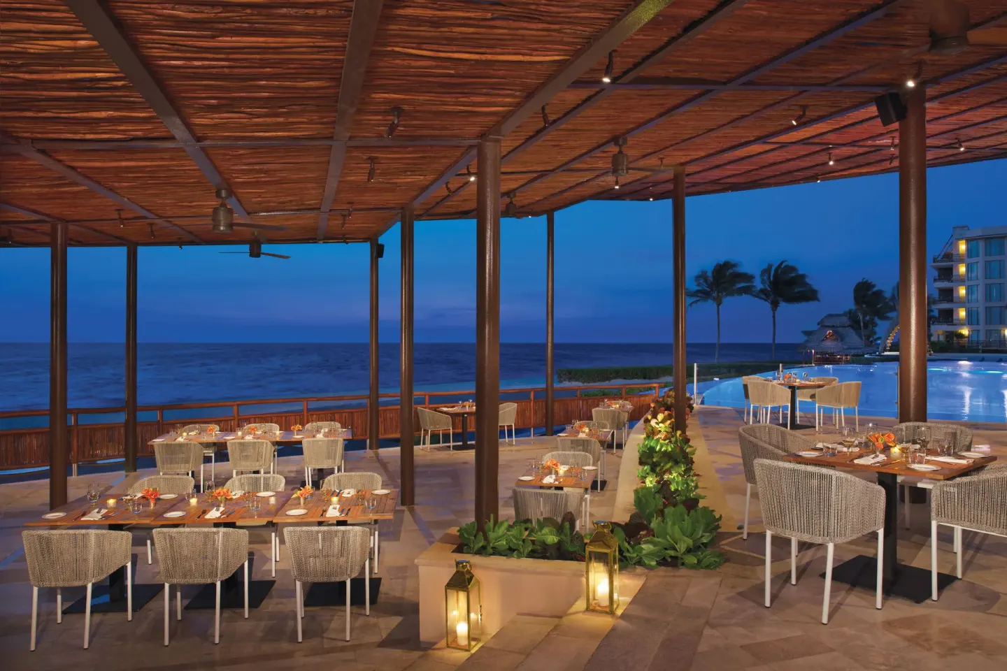 Open-air oceanfront dining terrace at Dreams Riviera Cancun Resort & Spa.