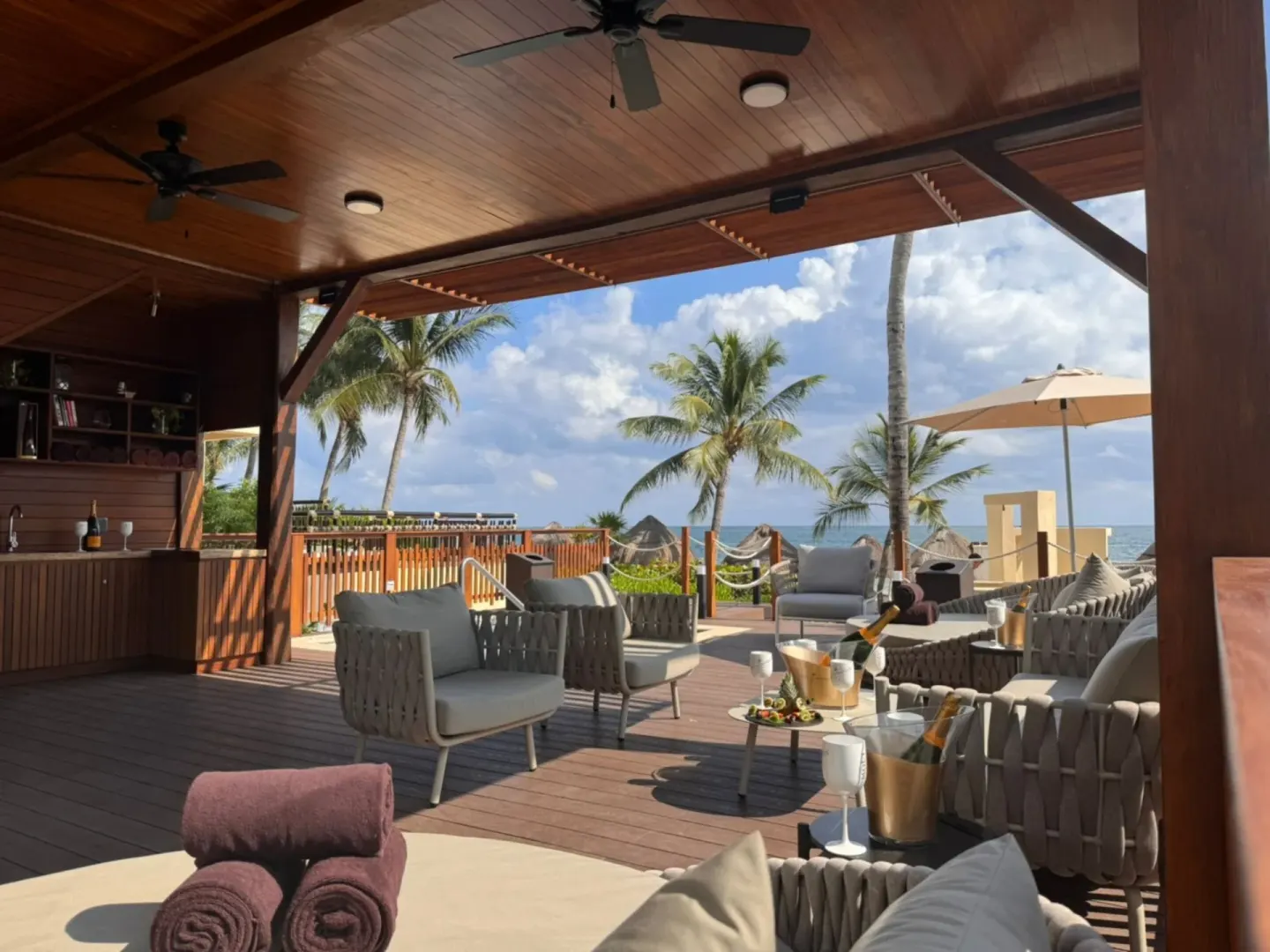 An open-air lounge terrace with ocean views at Dreams Riviera Cancun Resort & Spa.