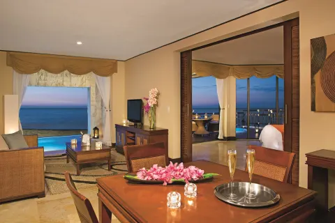 Oceanfront Governor Suite living and dining area at Dreams Riviera Cancun Resort & Spa.