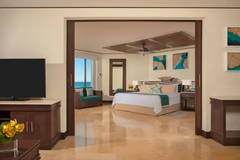 premium Ocean Front Master Suite king bed at Dreams Riviera Cancun Resort & Spa.
