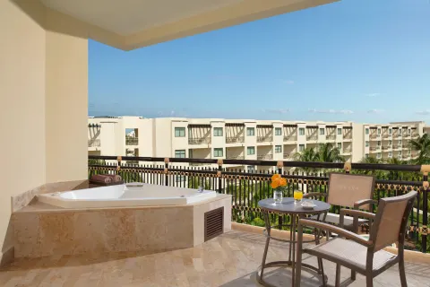 premium Tropical View balcony with soaking tub at Dreams Riviera Cancun Resort & Spa.