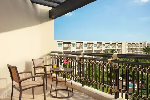 Furnished balcony with chairs at Dreams Riviera Cancun Resort & Spa.