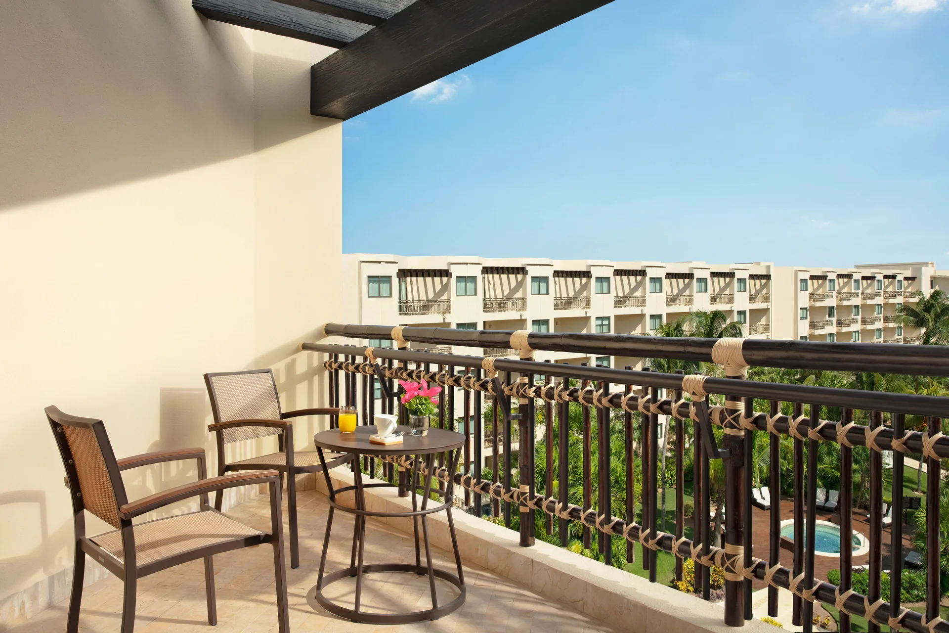 Furnished balcony with chairs at Dreams Riviera Cancun Resort & Spa.