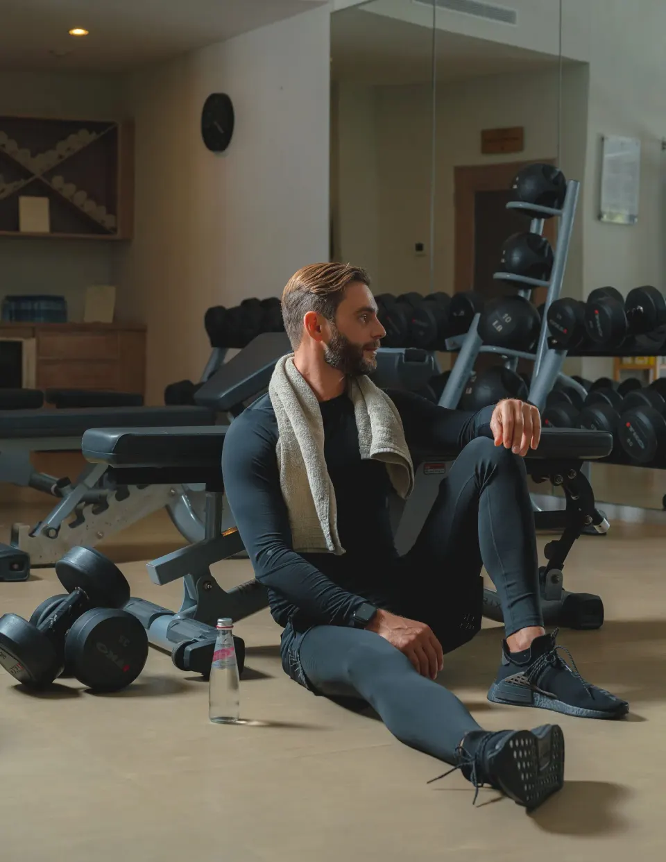 Guest resting beside dumbbells and benches in the fitness center at Eden Roc Cap Cana.