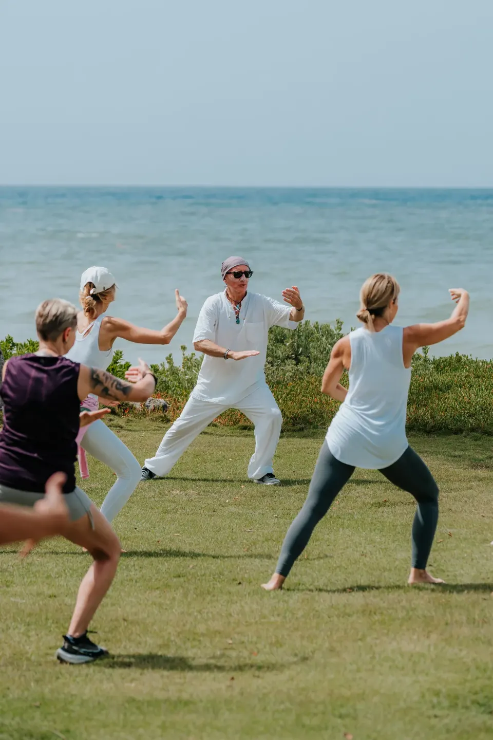 Guests practice tai chi on an oceanfront lawn at Eden Roc Cap Cana.