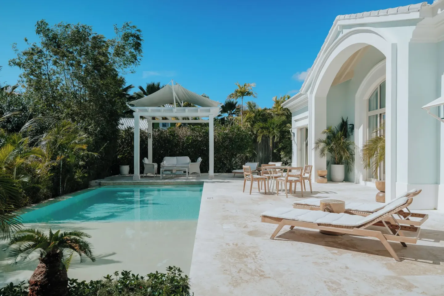 Private pool terrace with loungers and white villa exterior at Eden Roc Cap Cana.