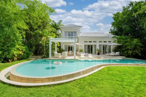 White villa with a curved private pool and garden at Eden Roc Cap Cana.