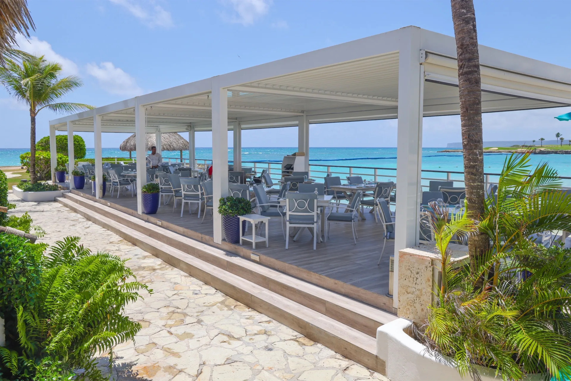 Open-air seaside restaurant terrace with ocean views at Eden Roc Cap Cana.