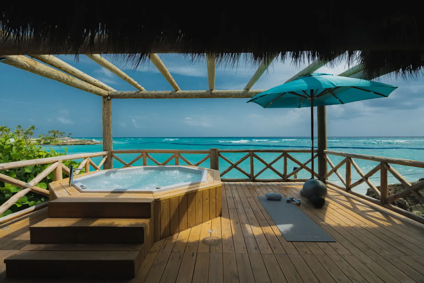 Oceanfront bungalow deck with hot tub and sea view at Eden Roc Cap Cana.