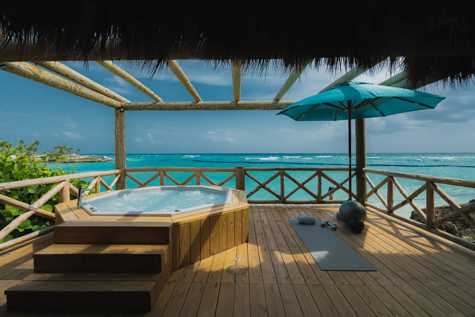 Oceanfront bungalow deck with hot tub and sea view at Eden Roc Cap Cana.