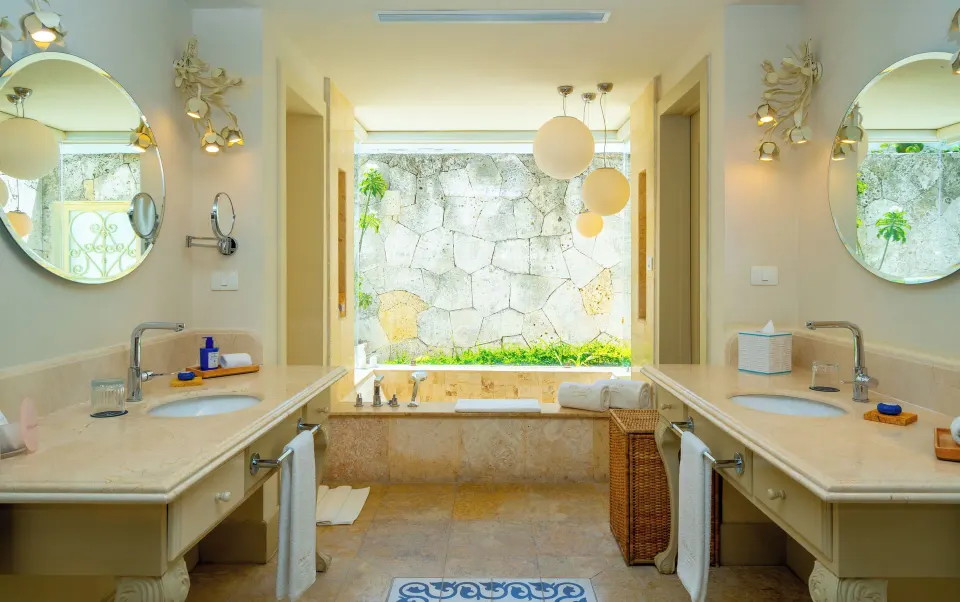 Four Bedroom Imperial Villa bathroom with twin vanities and soaking tub at Eden Roc Cap Cana.