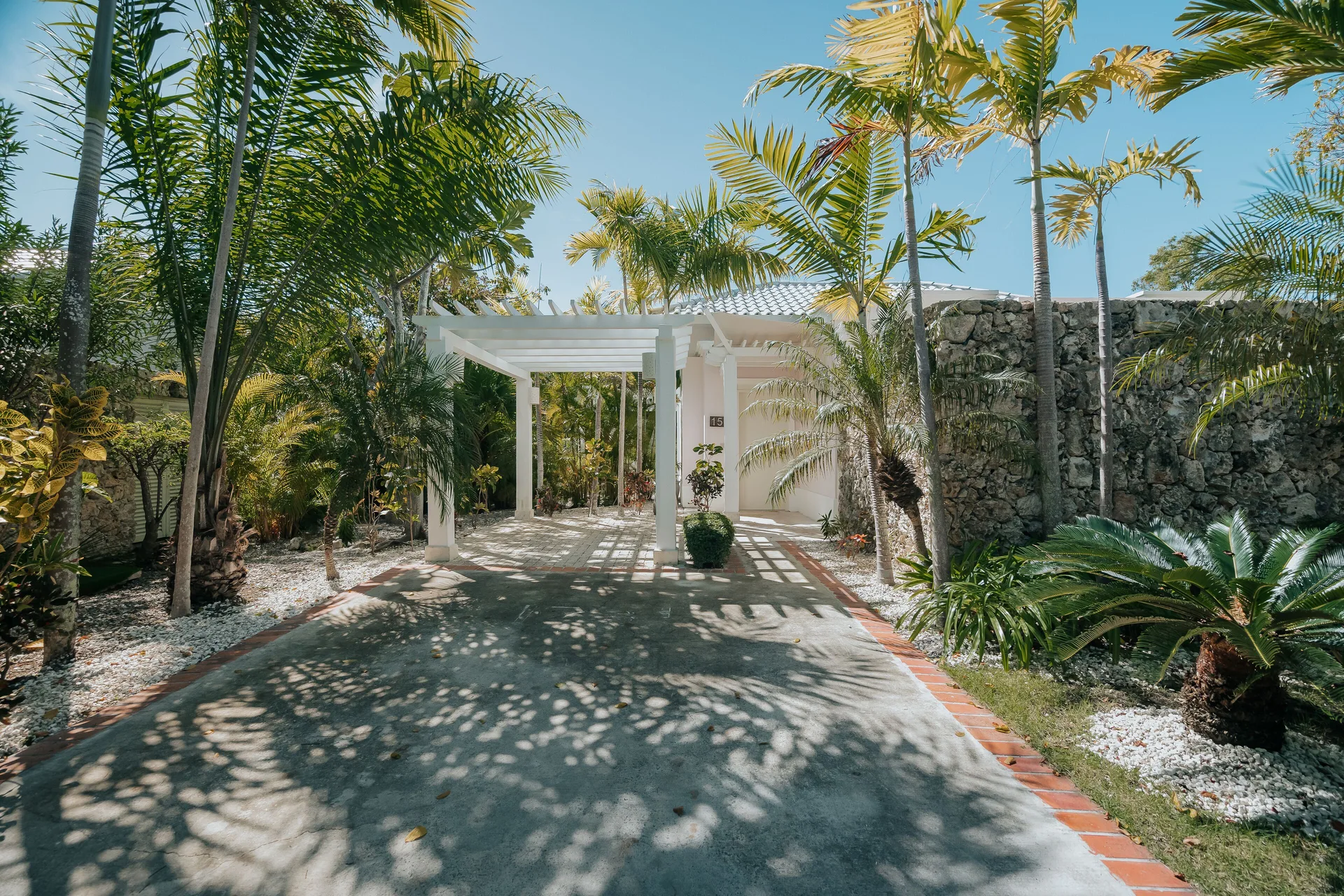 Palm-lined private entrance to a Luxury Pool Junior Suite at Eden Roc Cap Cana.