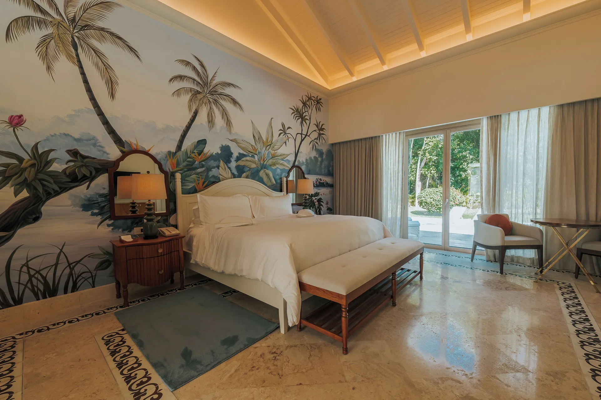 Luxury Pool One Bedroom Suite king bed beside sliding glass doors at Eden Roc Cap Cana.