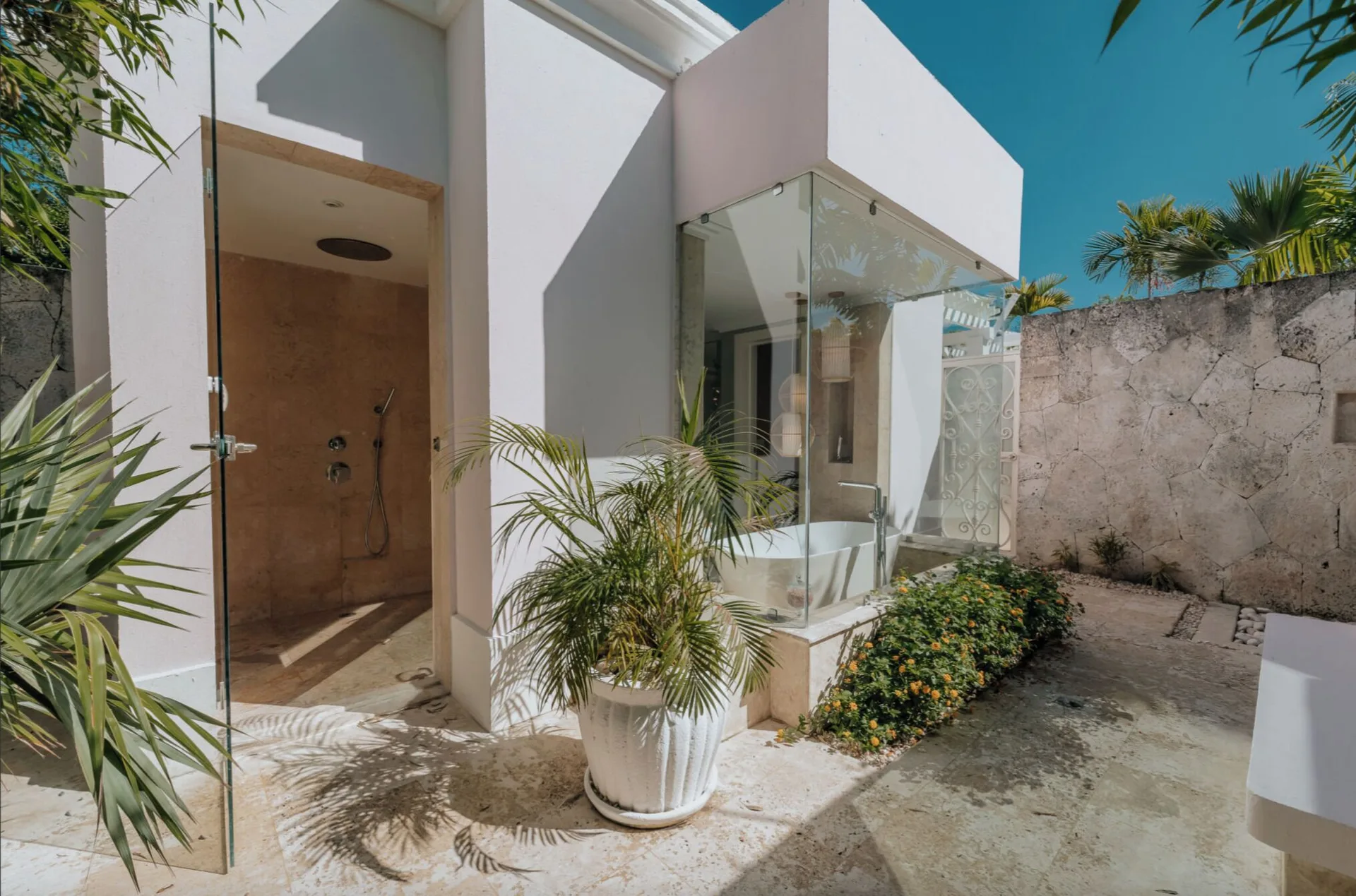 Luxury Pool One Bedroom Suite outdoor shower and glass bathing area at Eden Roc Cap Cana.