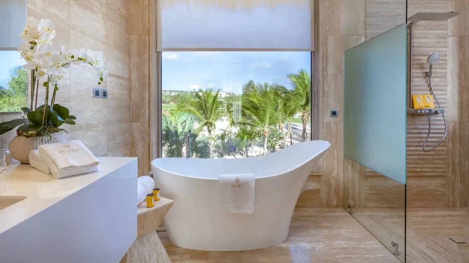 Beachfront suite bathroom with soaking tub and shower at Eden Roc Cap Cana