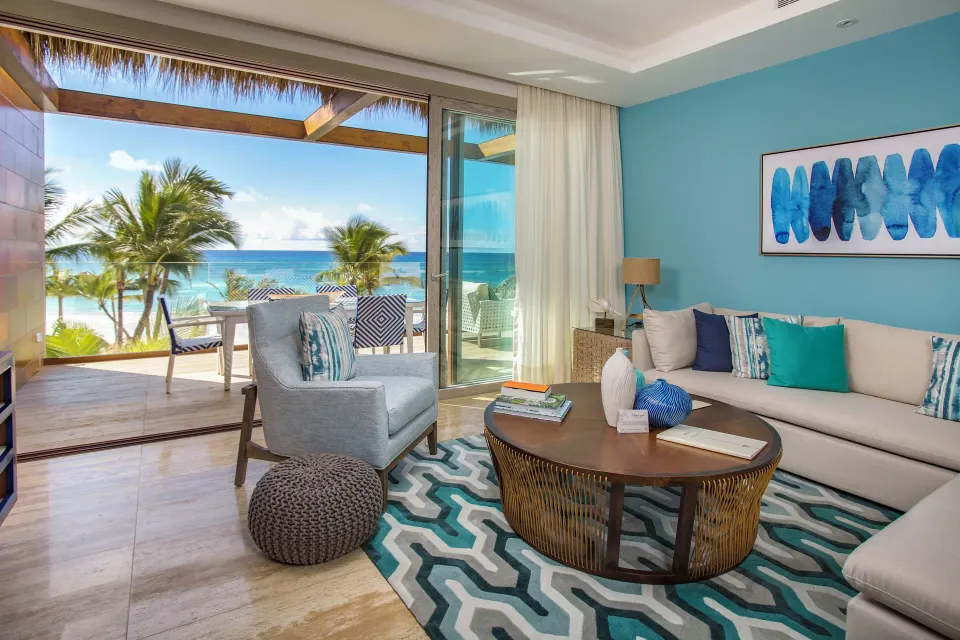 Beachfront one-bedroom suite living room and terrace at Eden Roc Cap Cana.