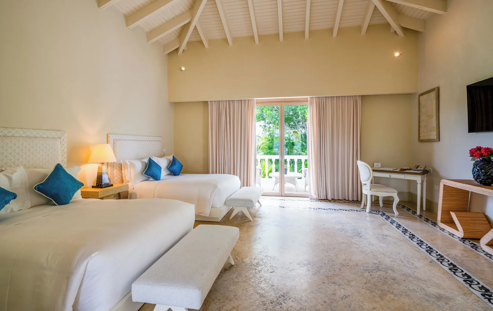 Three Bedroom Royal Villa bedroom with two beds and balcony at Eden Roc Cap Cana.