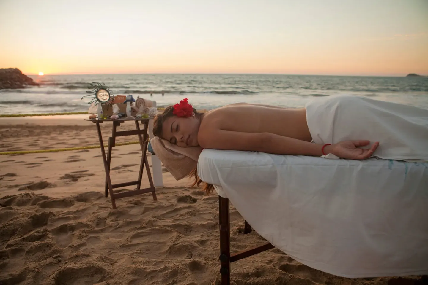 A beach massage setup faces the sunset and ocean at El Cid Castilla Beach Hotel.