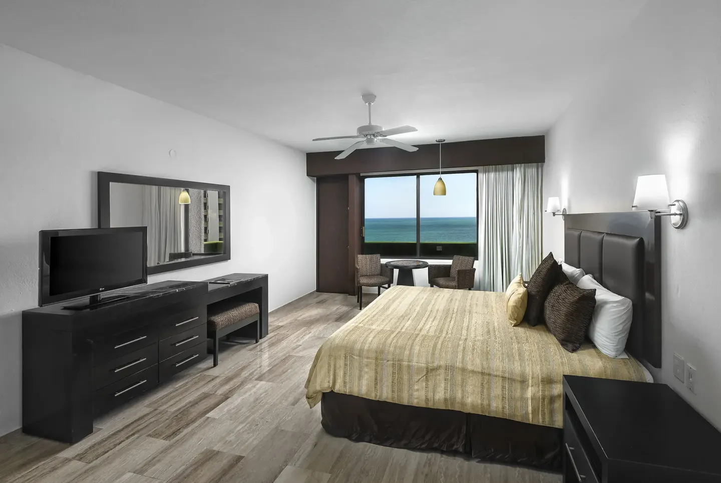 King bed ocean view guest room at El Cid Castilla Beach Hotel.