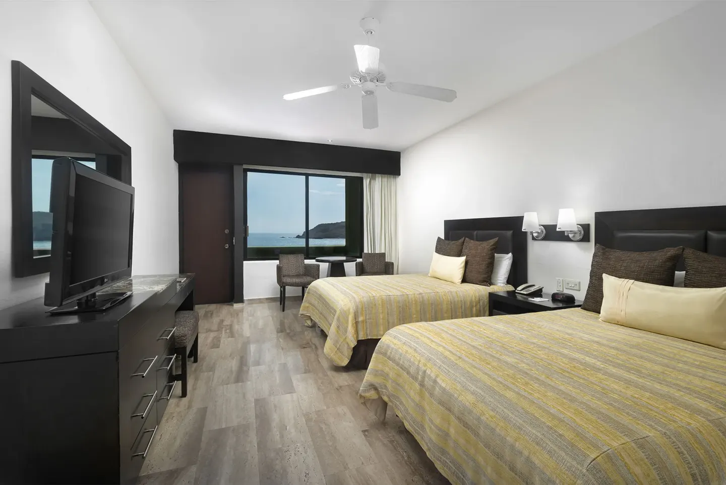 Two-bed ocean view guest room at El Cid Castilla Beach Hotel.