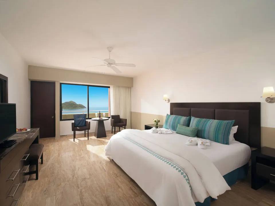 Standard Ocean View king room with seating by the window at El Cid Castilla Beach Hotel.