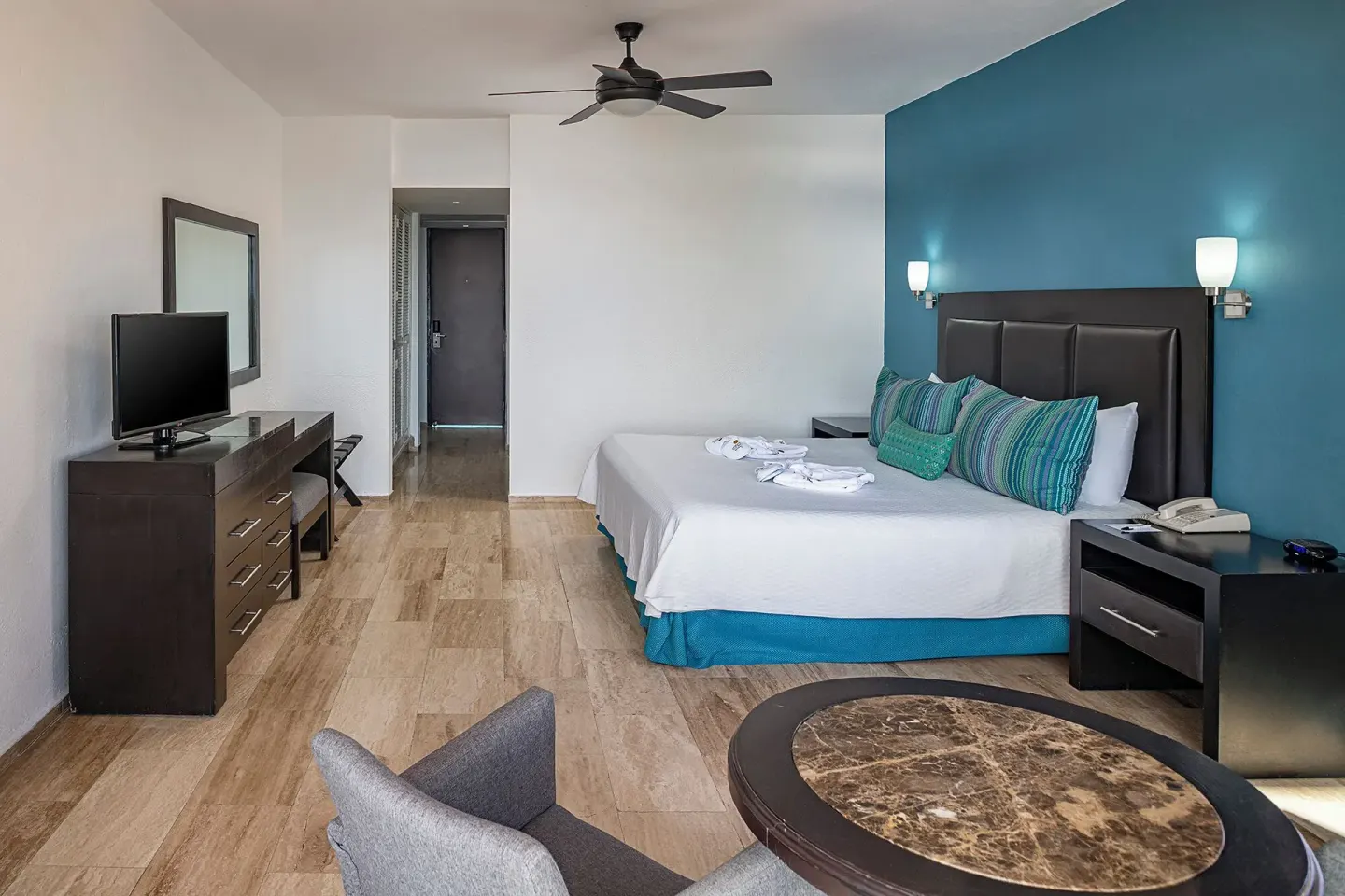Standard Ocean View king room with teal accent wall at El Cid Castilla Beach Hotel.