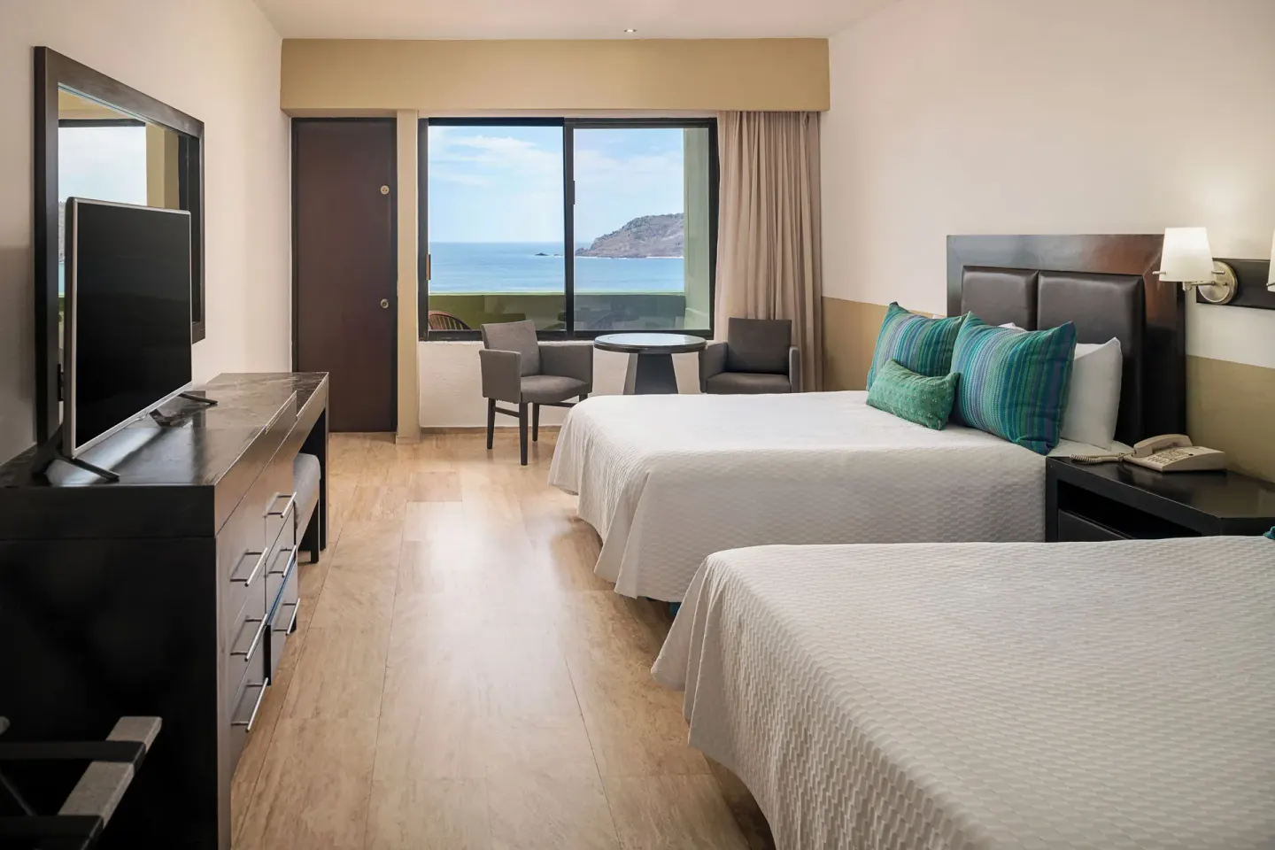 Standard Ocean View room with two beds and ocean-facing window at El Cid Castilla Beach Hotel.