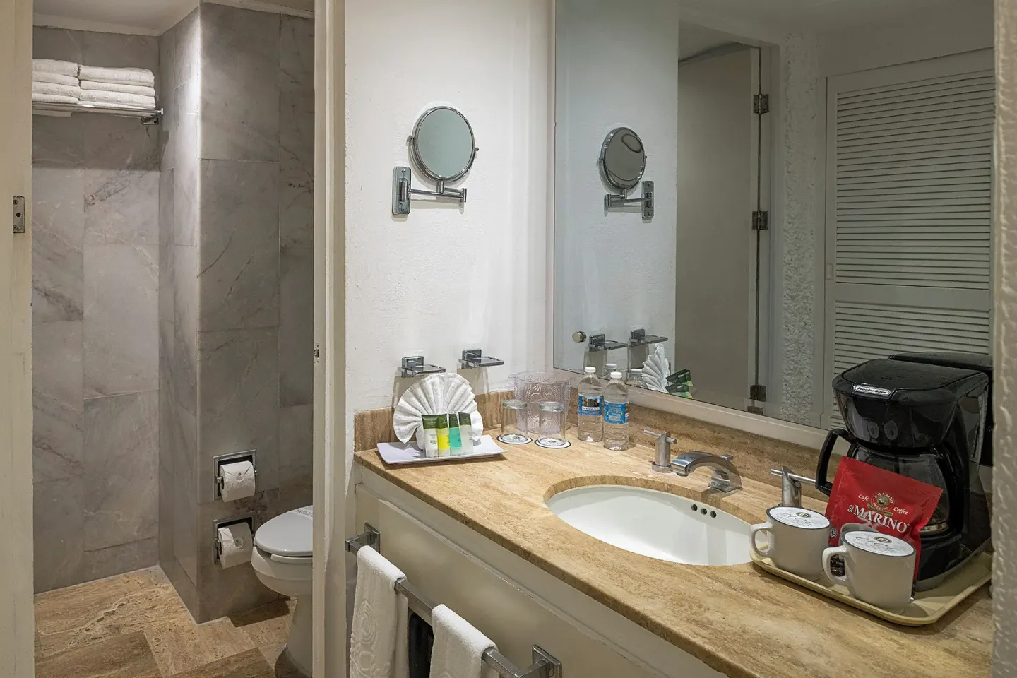 Standard Pool View bathroom vanity and shower area at El Cid Castilla Beach Hotel.