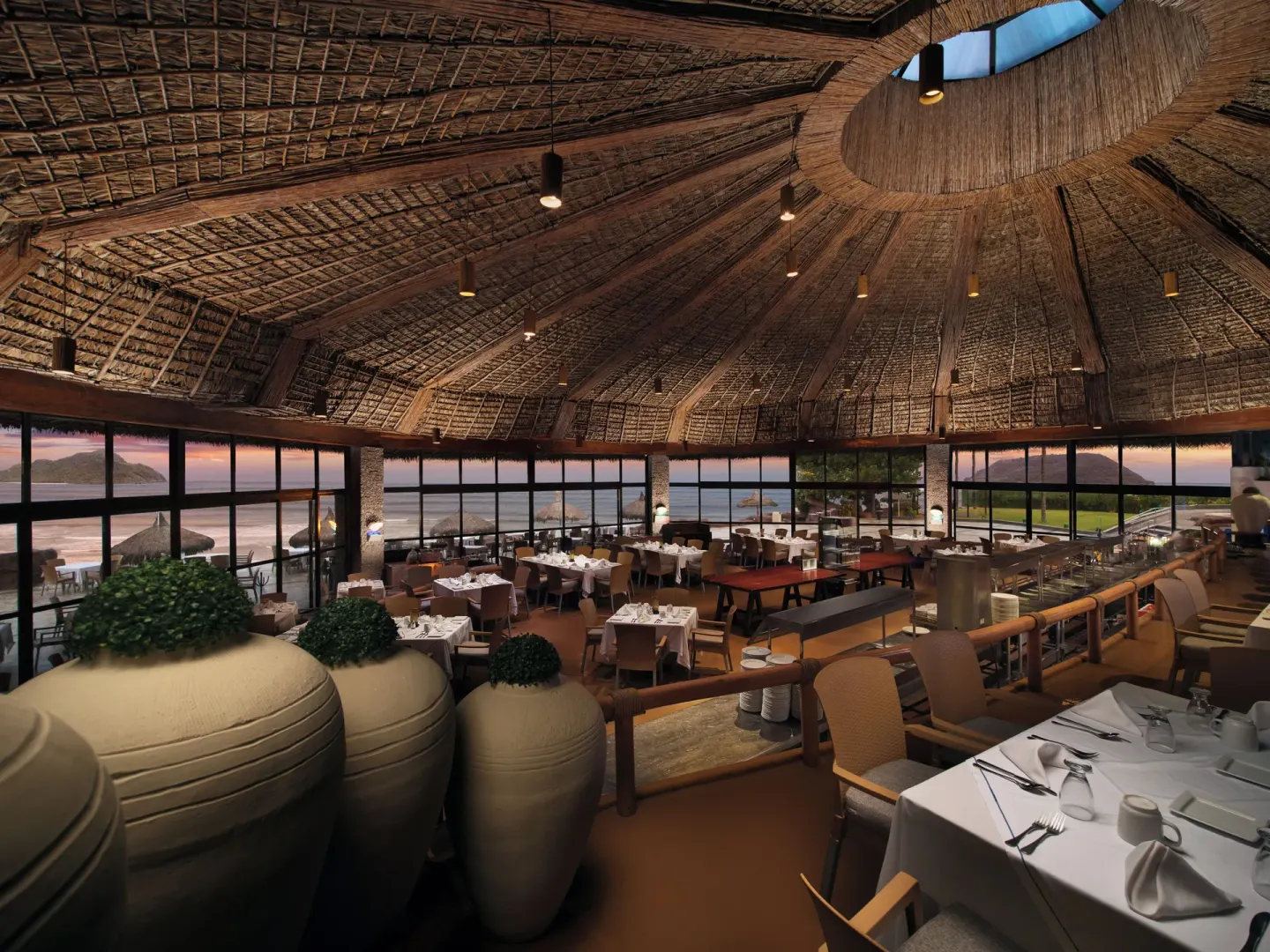 Thatched-roof oceanview restaurant dining room at El Cid El Moro Beach Hotel.