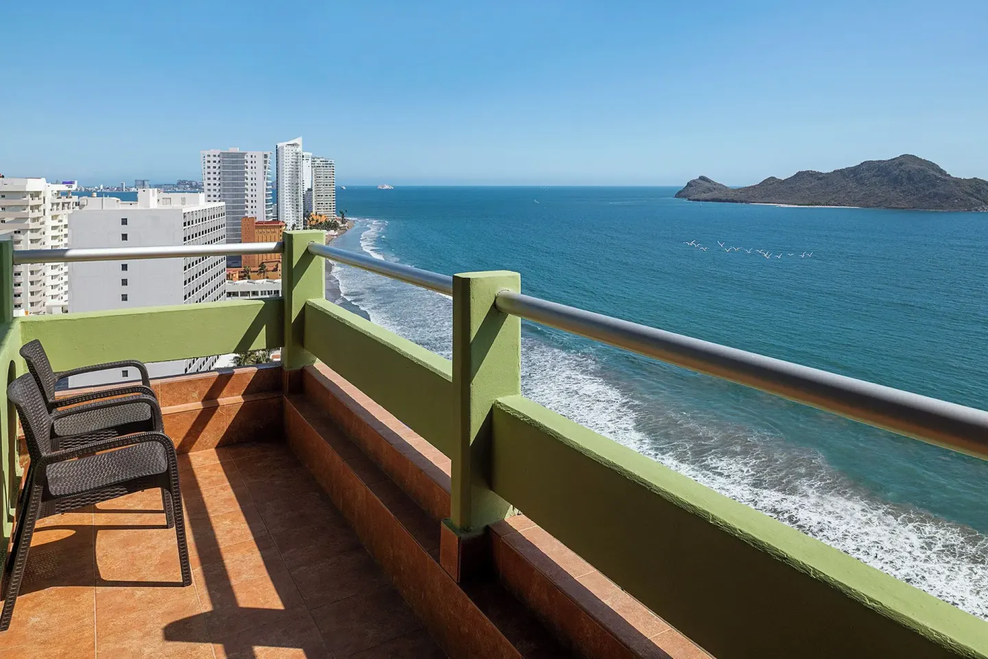 Oceanfront balcony with chairs at the One Bedroom Suite at El Cid El Moro Beach Hotel.