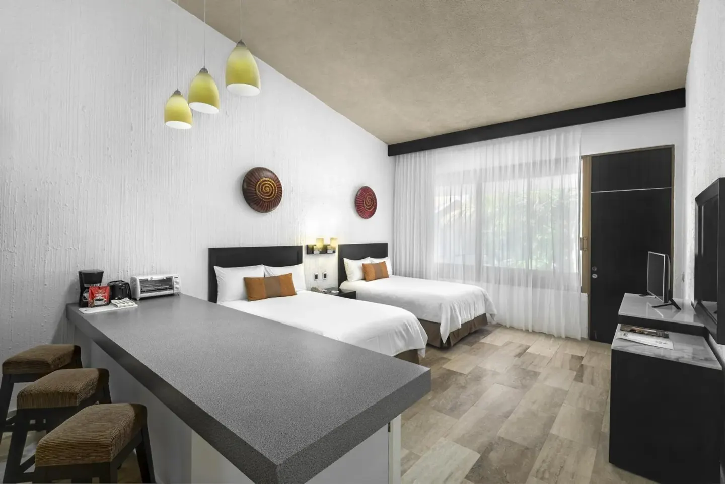Two-bed guest room with breakfast counter and TV at El Cid Granada Hotel.