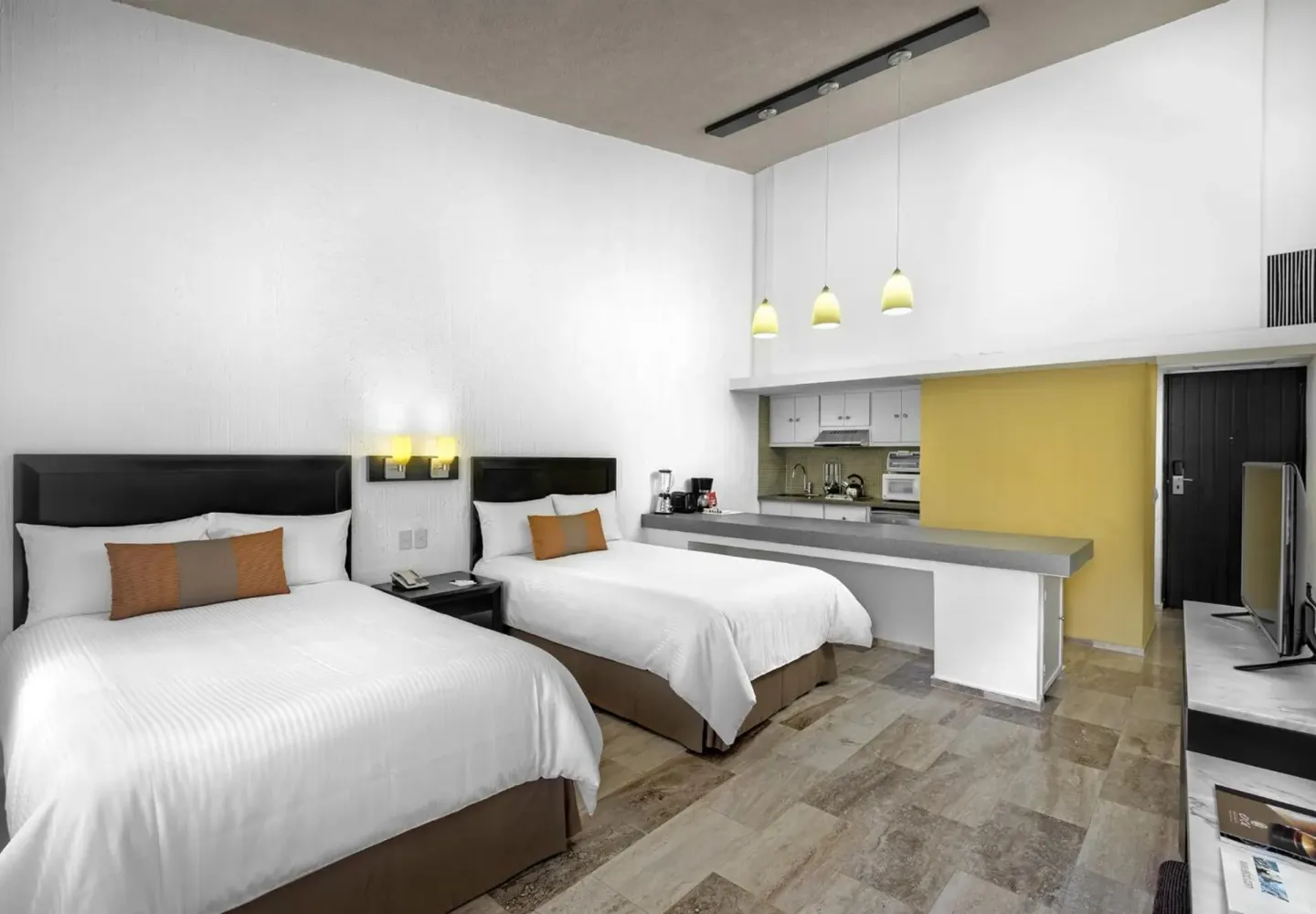 Guest room with two double beds, kitchenette counter and TV at El Cid Granada Hotel.