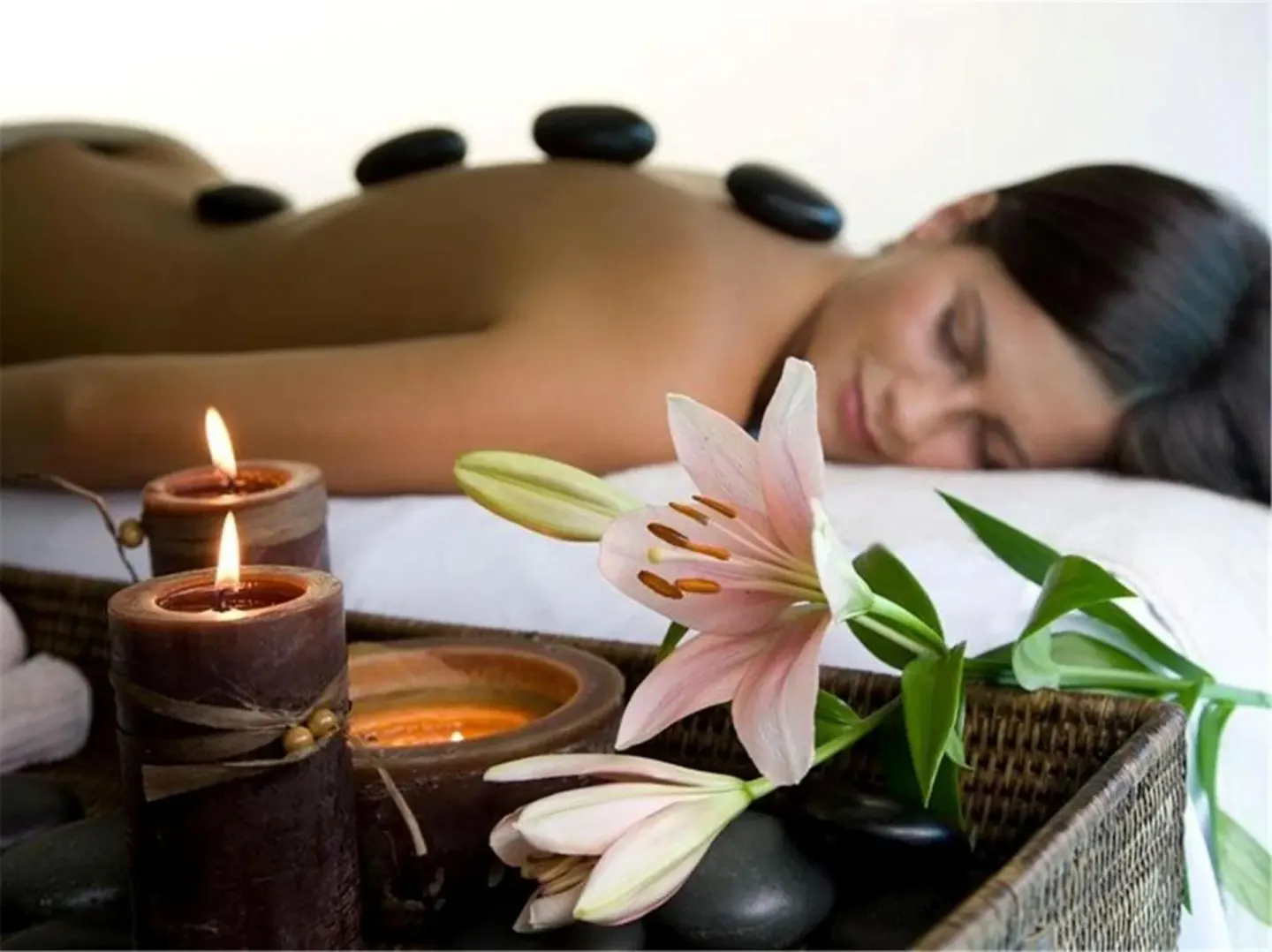 Spa treatment with hot stones, candles and lilies at El Cid Granada Hotel.