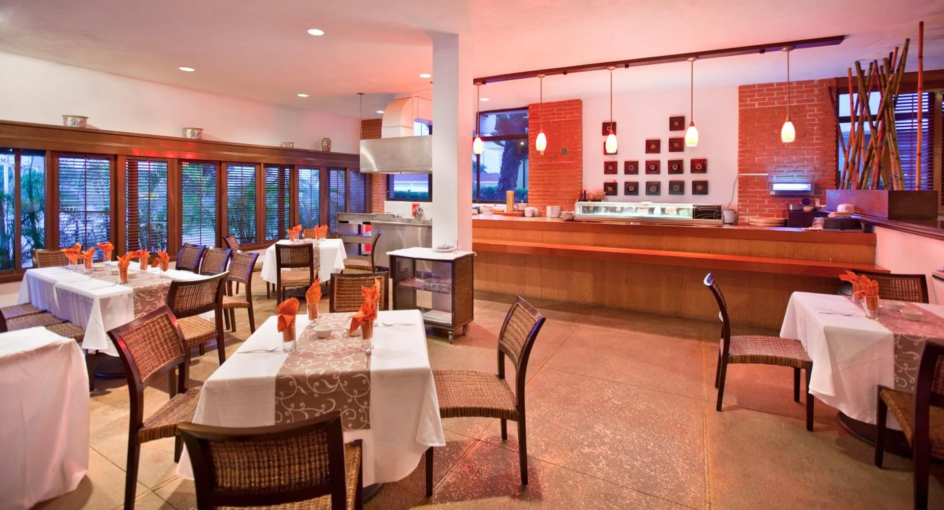 Sushi bar dining room with set tables at El Cid Granada Hotel.