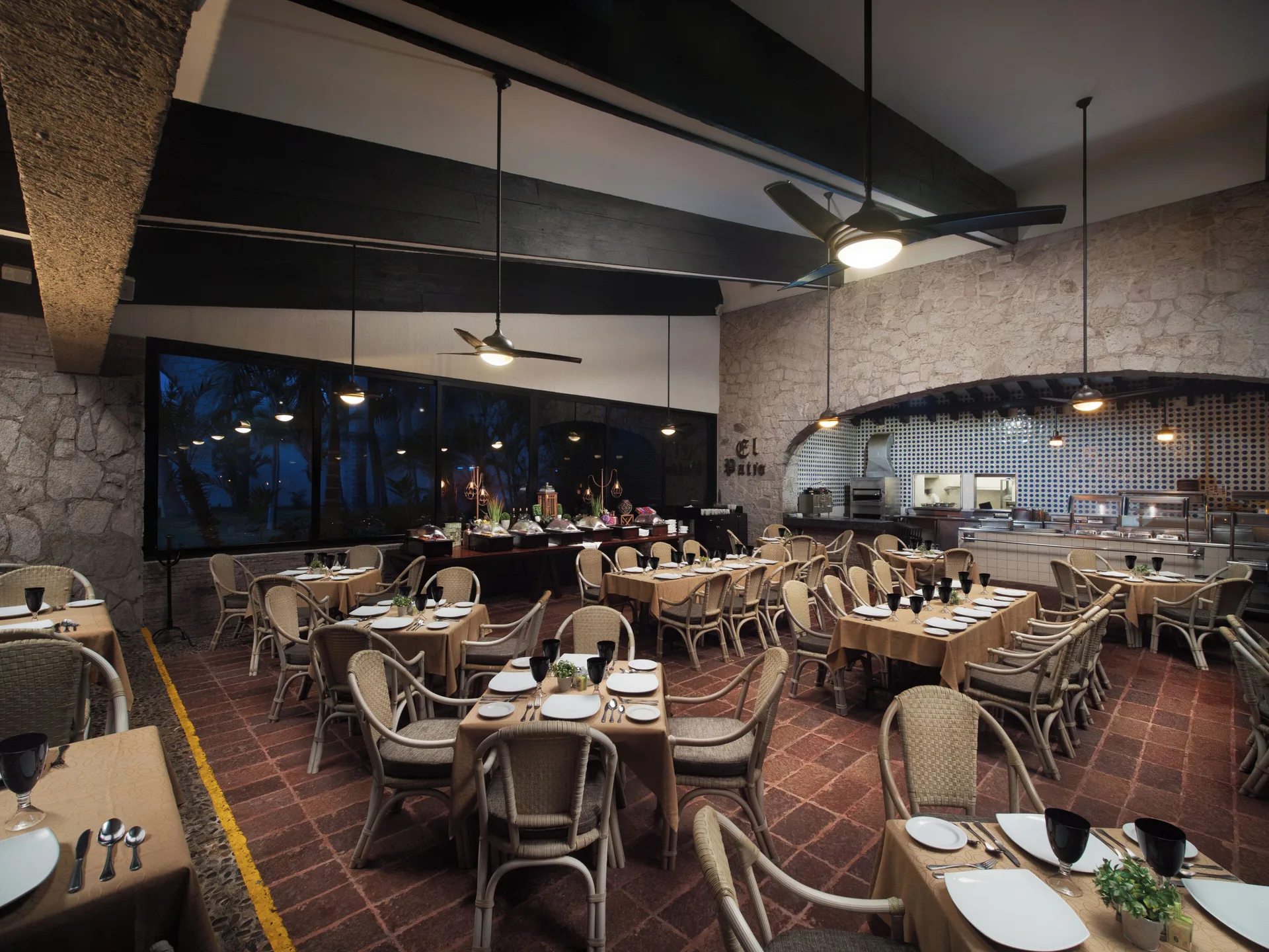 El Patio dining room with set tables and buffet area at El Cid Granada Hotel.