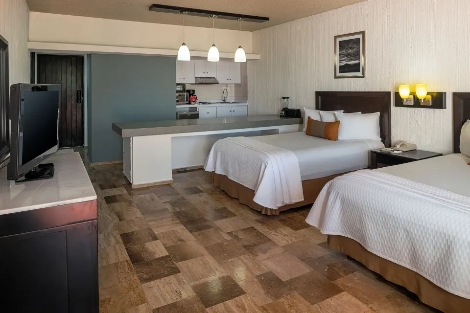 One Bedroom Suite with two beds and kitchenette at El Cid Granada Hotel.