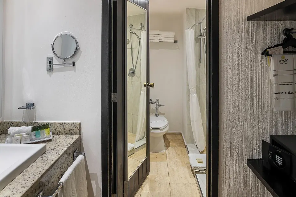 Studio Room bathroom and closet area at El Cid Granada Hotel.