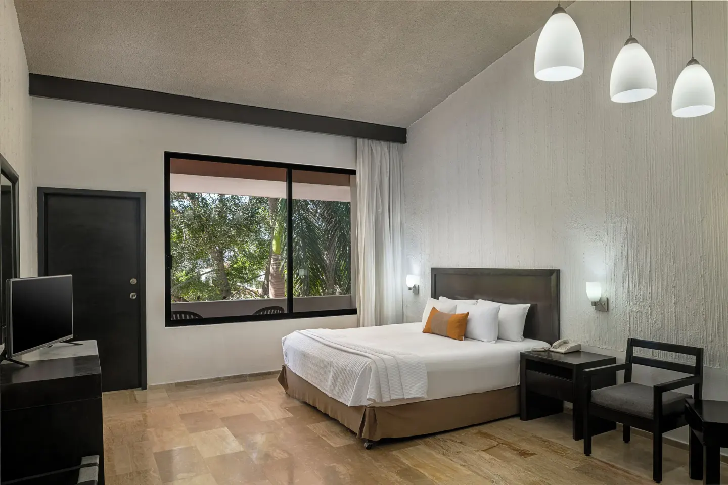 Studio Room with king bed and large window at El Cid Granada Hotel.
