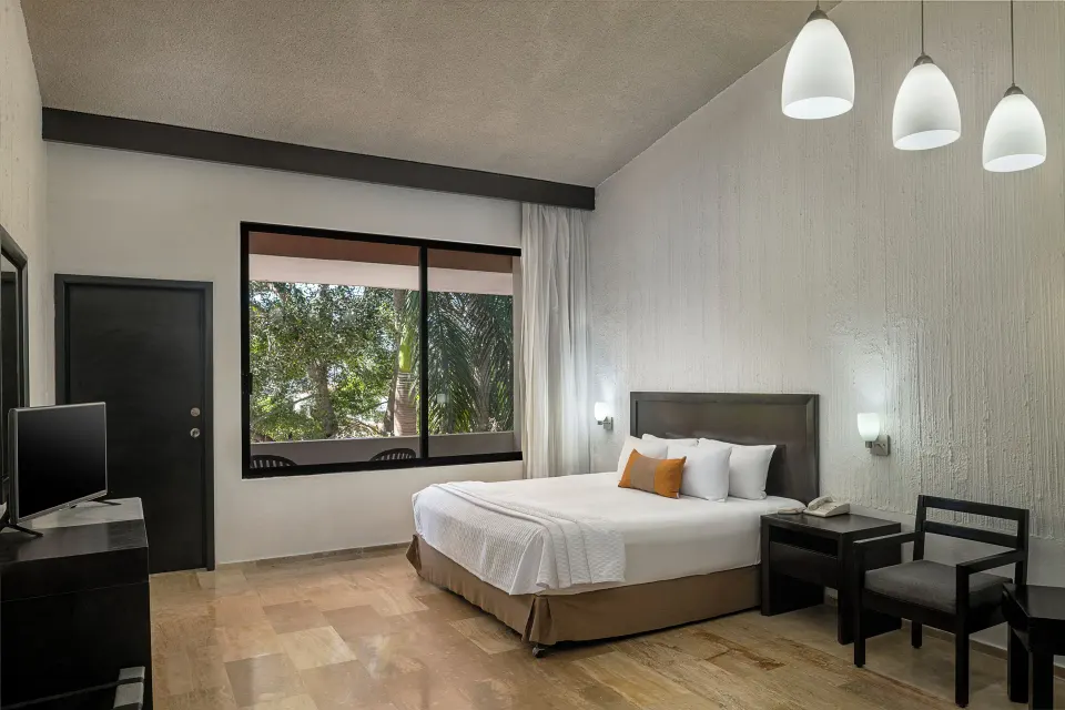 Studio Room with king bed and large window at El Cid Granada Hotel.