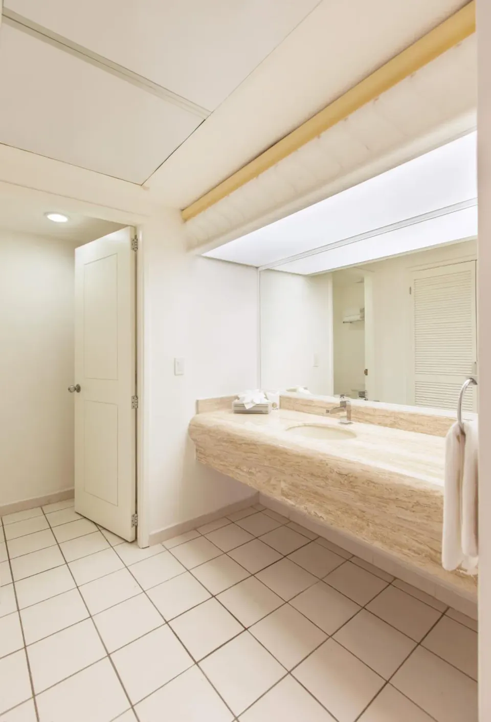 Guest bathroom vanity and mirror at El Cid Marina Beach Hotel.