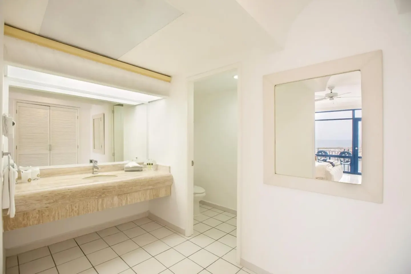 Suite bathroom vanity and mirror at El Cid Marina Beach Hotel.