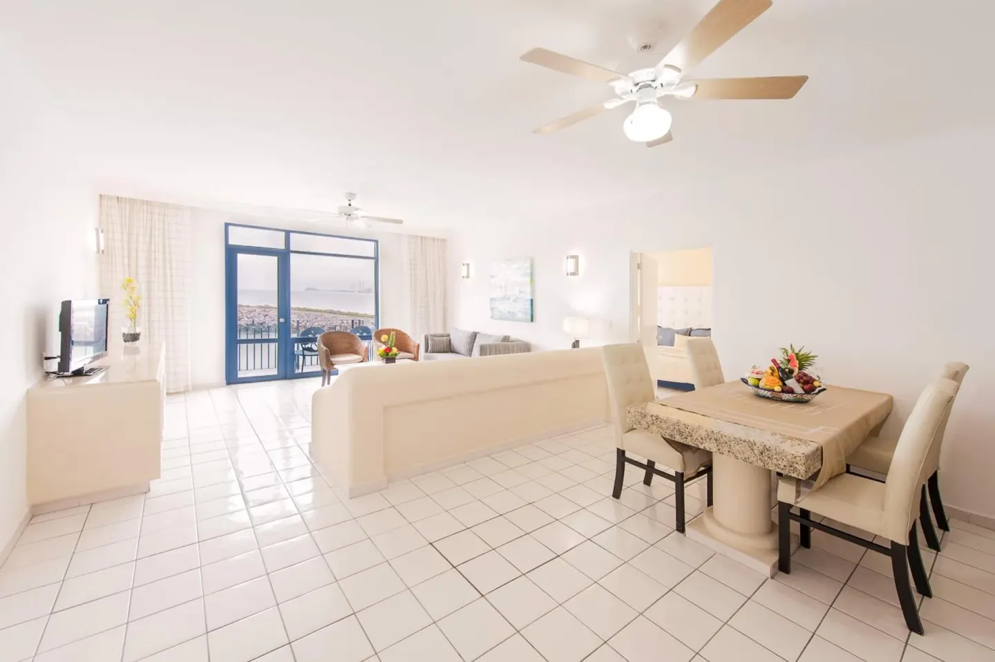 Bright suite dining and living area at El Cid Marina Beach Hotel.