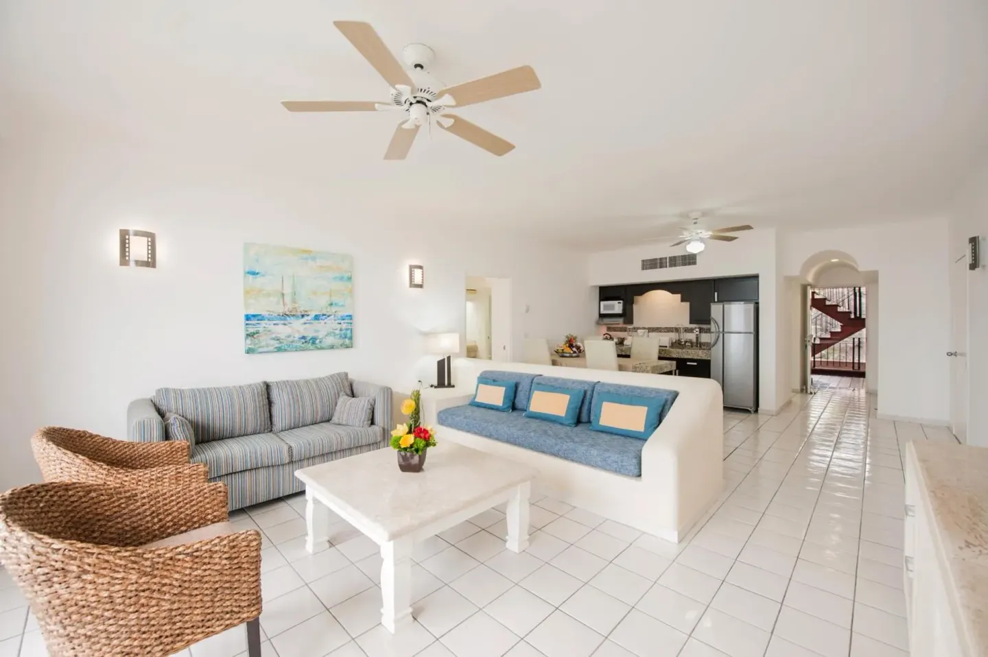 Suite living area with sofas and kitchenette at El Cid Marina Beach Hotel.