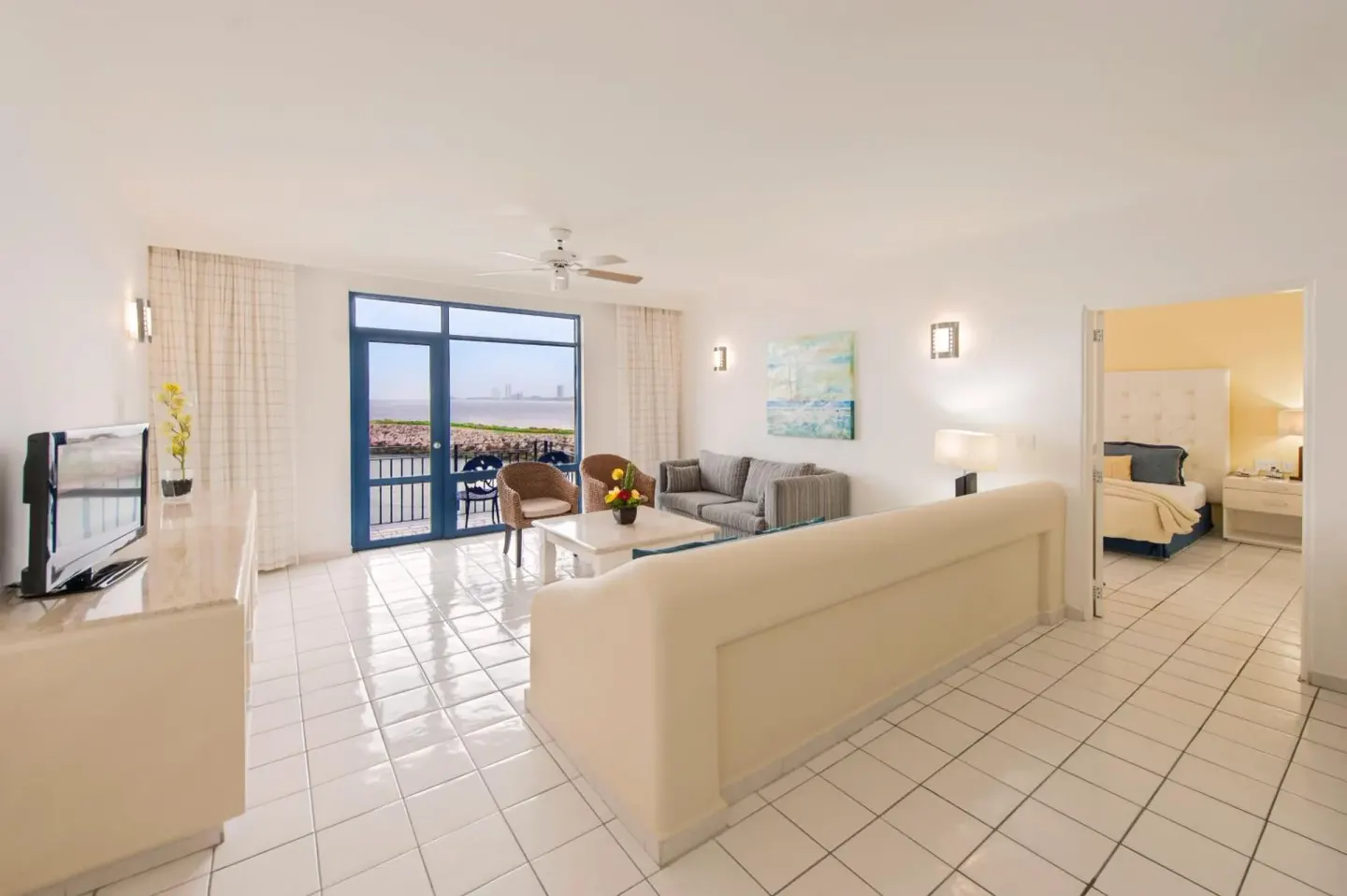 Suite living room and separate bedroom at El Cid Marina Beach Hotel.