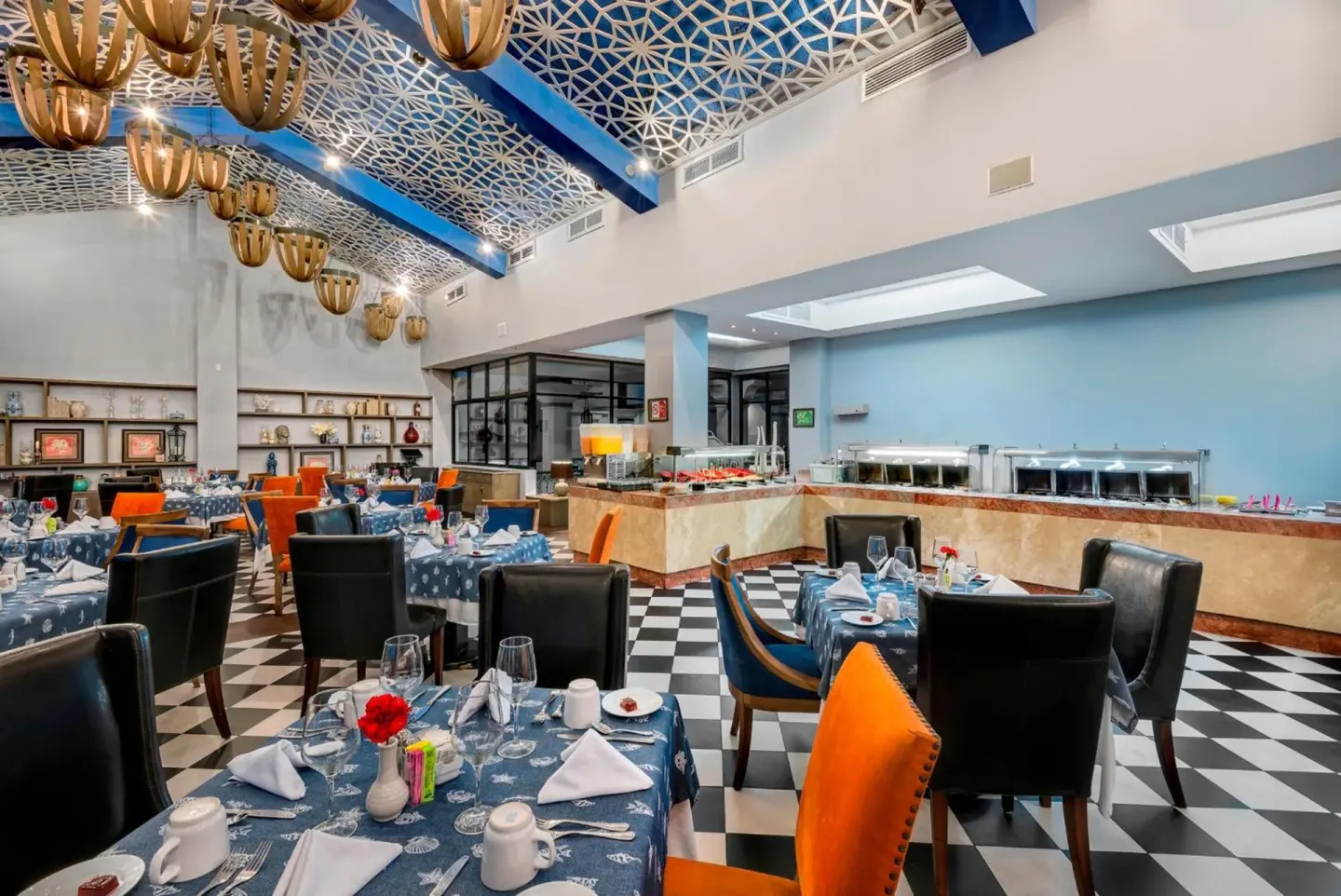 Buffet dining room with set tables at El Cid Marina Beach Hotel.
